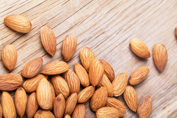Detail shot of many almonds on a wooden background