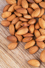 Detail shot of many almonds on a wooden background