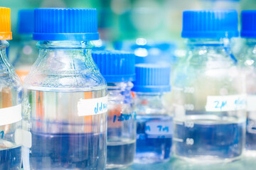 Rows of liquid chemicals in bottles at chemistry