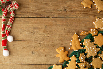 christmas gingerbread cookies lie in a green string bag on a light brown wooden background