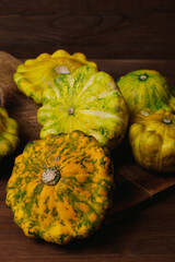 Colorful pattypan squash on wooden board. 