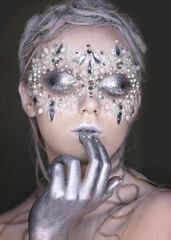 Close-up portrait of a girl with creative makeup.