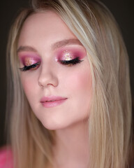 Close-up portrait of a girl with pink makeup.