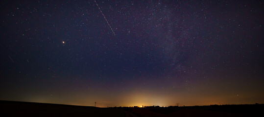 Night landscape with light from the city on the horizon