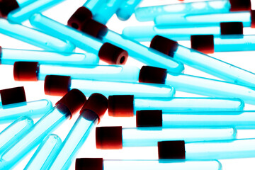 Colored test tubes on white background . Flat lay. Flatly.