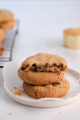 Oatmeal cookies with raisins and nuts on a white background.