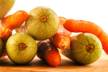 carrots and zucchini close up on wooden board