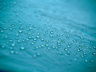 Water drops on blue fabric.