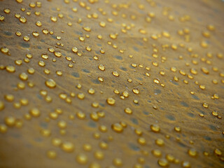 Water drops on yellow fabric.