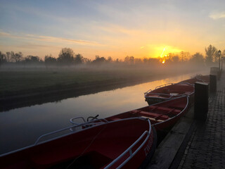 boat on the river near meadow at sunrise in the village of Giethoorn, Holland Netherlands
