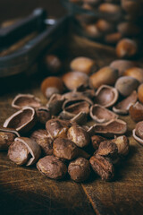 Whole nuts, shelled nuts and shells. Corylus avellana. Macro photo, close up, on wooden table.