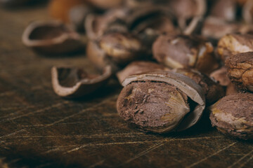 Whole nuts, shelled nuts and shells. Corylus avellana. Macro photo, close up, on wooden table.