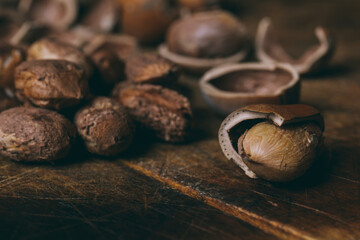 Whole nuts, shelled nuts and shells. Corylus avellana. Macro photo, close up, on wooden table.