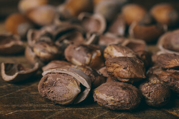 Whole nuts, shelled nuts and shells. Corylus avellana. Macro photo, close up, on wooden table.