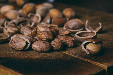 Whole nuts, shelled nuts and shells. Corylus avellana. Macro photo, close up, on wooden table.