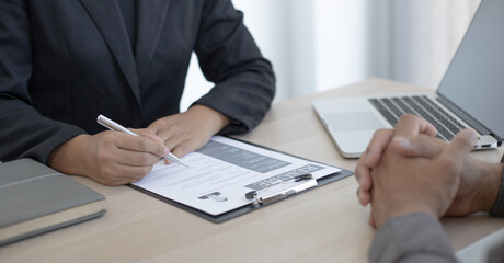 Fototapeta premium HR head is interviewing a young man's job application in a private room.