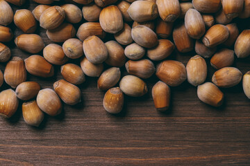 Pile of nuts. Whole nuts. Hazelnuts.Macro photo, close up, top view on wooden table.