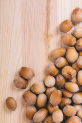 Pile of nuts. Whole nuts. Corylus avellana. Macro photo, close up, top view on wooden table.