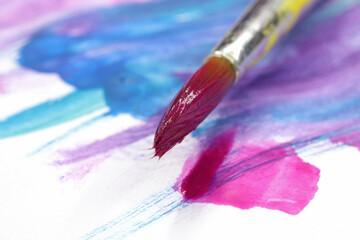 Fototapeta premium close-up brush and paint on colored background