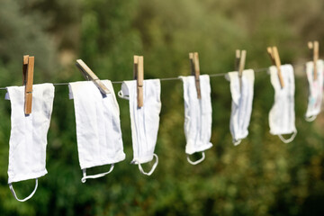 Reusable medical masks hanging on drying equipment for reuse. Masks to protect against viruses and prevent the spread of viruses due to insufficient masks.