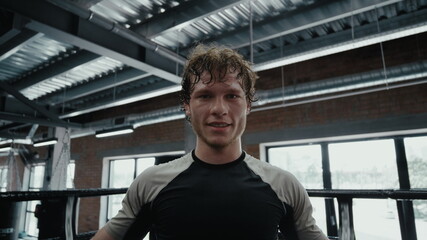 Joyful kickboxer winning fight at gym. Fighter rejoicing in fitness center