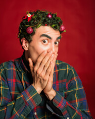 man in a plaid shirt on a red background in new year costume christmas mood green hair funny