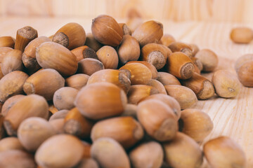 Pile of nuts. Whole nuts. Corylus avellana. Close up, on wooden background.