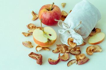 Apples, fresh and dry, in a small cloth bag on a light background. Selective focus. Tinted photo.