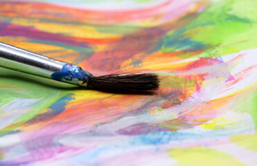 close-up brush and paint on colored background