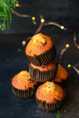 muffins cupcakes vanilla hocolate drops homemade baking cakes on the table christmas lights new year treat tasty top view copy space for text food background rustic