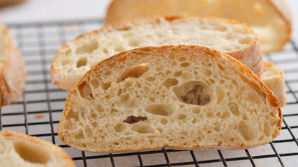 Homemade ciabatta cools down on a wire rack.