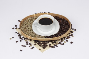 Serving black coffee on a white background, sprinkled with coffee beans.