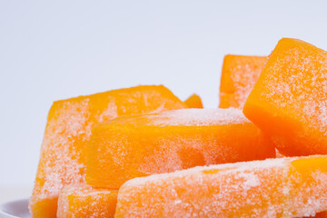 Frozen pieces of pumpkin. Macro shot.