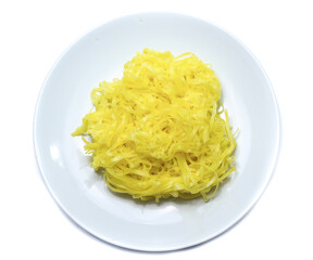 yellow noodles on dish isolated on white background