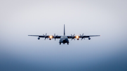 Military aircraft at landing, bad weather 