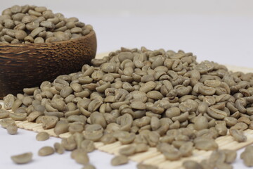 The pile of fresh coffee beans is green, showing the quality coffee beans and ready to be roasted.
