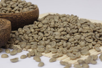 The pile of fresh coffee beans is green, showing the quality coffee beans and ready to be roasted.