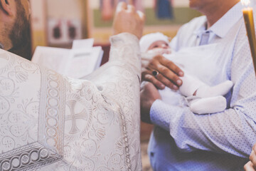 The sacrament of the baptism of a child. Selective focus.