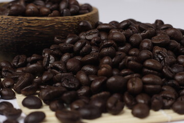 pile of roasted coffee beans, exotic black and emitting a distinctive aroma of coffee.