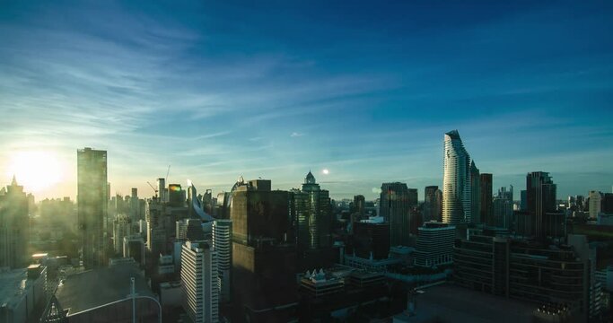 4K timelapse landscape view of the metropolitan city center of Bangkok in Thailand while the sunrise in the morning with clear blue sky
