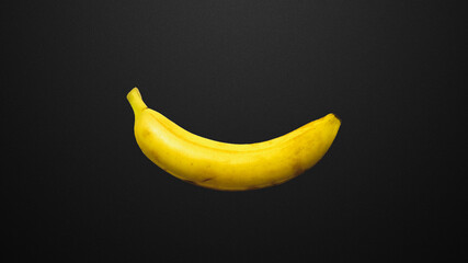 Yellow banana on a black background. 
