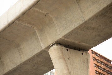 Up view and close up shot of concrete road bridge in the urban area of the city shows texture of grunge and stain for main transportation which performs high strength with the support of the beams
