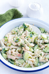 salad with calamari and fresh cucumbers and herbs, selective focus
