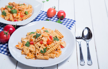 Spaghetti pasta with and tomato sauce on wood background