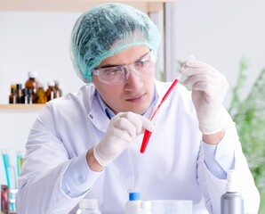 Blood testing in the lab with young scientist