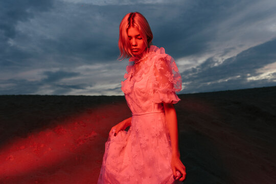 woman at sunset illuminated by red light