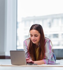 Young girl surfing internet on laptop