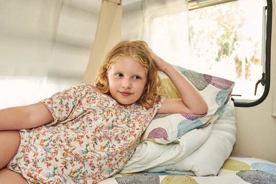 Girl lying in a caravan. She is relaxed on her vacation.