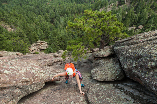 Woman climbs Second Flatiron without rope above Boulder, Colorado