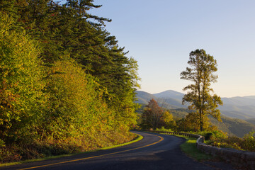 Colorful trees along the historic Blue Ridge Parkway at sunset in the Virginia mountains.